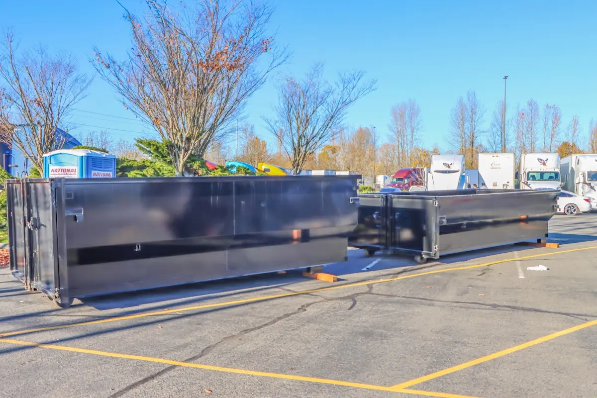 Professional dumpster rental service with roll-off container on residential driveway in Hazel Crest